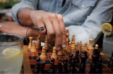 man playing chess with engraved gold signet ring