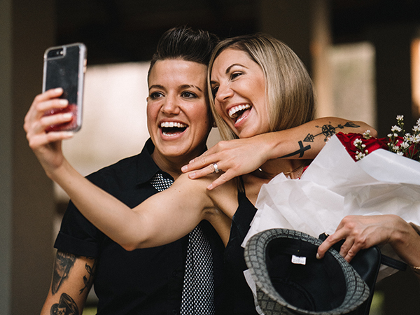 Karrie and Casey take a cellphone selfie with Casey's engagement ring.