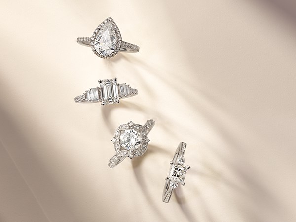 Four engagement rings with different styles.