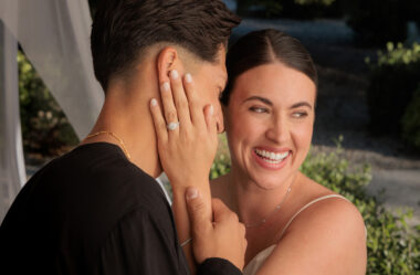 couple hugging and smiling highlighting their wedding and engagement ring