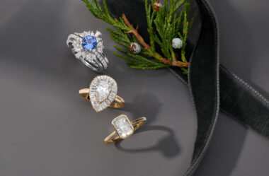 three engagement rings on a gray holiday background.